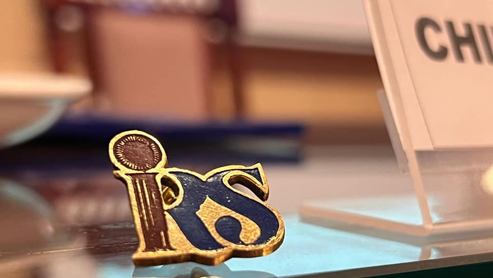 An IRSA pin displayed during a ceremony